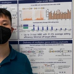 Qichen Yuan standing in front of poster